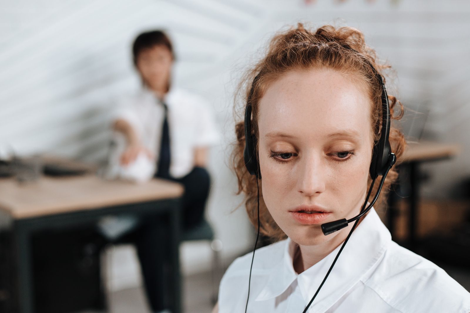 Professional receptionist using a headset in a modern office